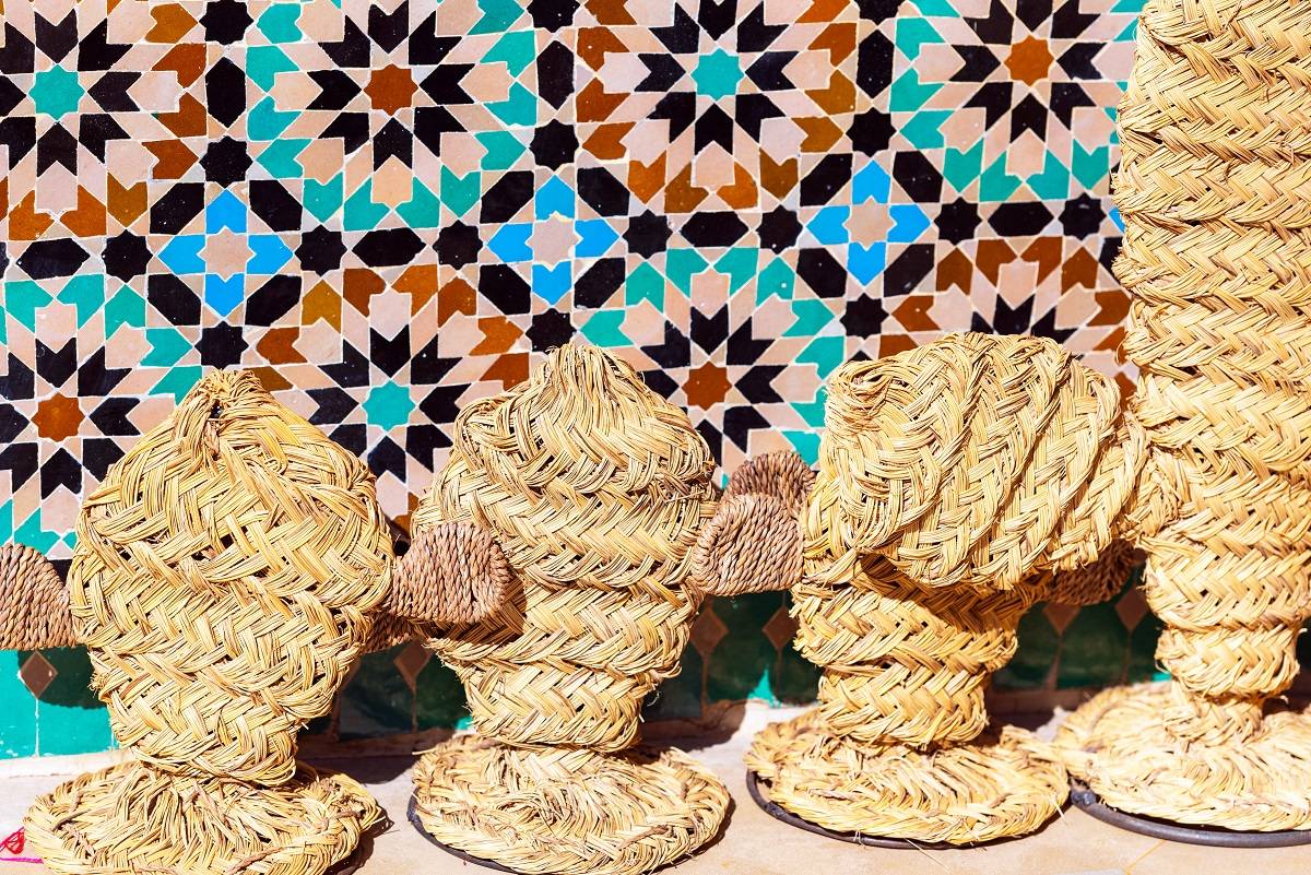 Woven cacti against colorful tile background.