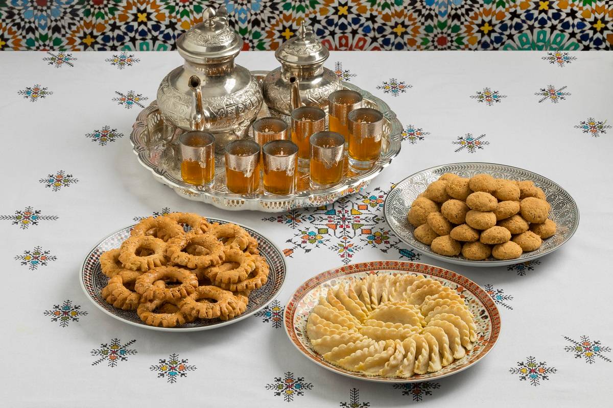 Moroccan cookies and tea service displayed.